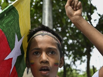 A young Rohingya refugee gathers with others at a camp in Cox's Bazar, Bangladesh, to mark the ninth anniversary of their mass exodus from Myanmar, on August 25, 2026.