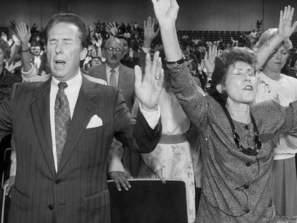 The Reverend John Osteen and wife Dodie lead Lakewood Church in prayer in Houston, Texas, on January 31, 1990.