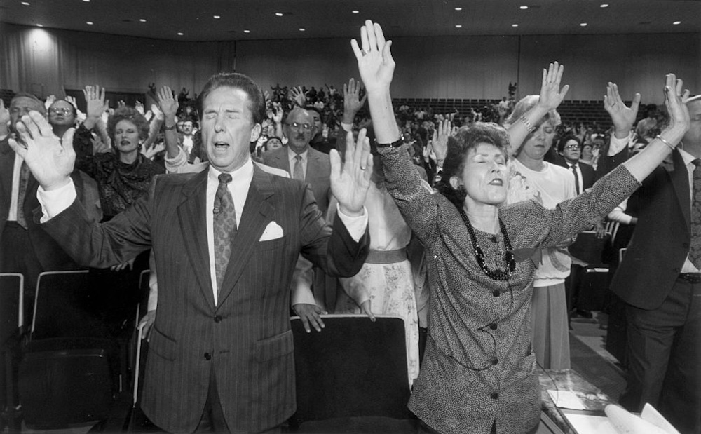 The Reverend John Osteen and wife Dodie lead Lakewood Church in prayer in Houston, Texas, on January 31, 1990.