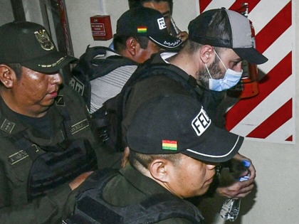 Police officers transfer Fernando Cerimedo from the Justice Palace to the Palmasola prison in Santa Cruz, Bolivia, on August 21, 2026.