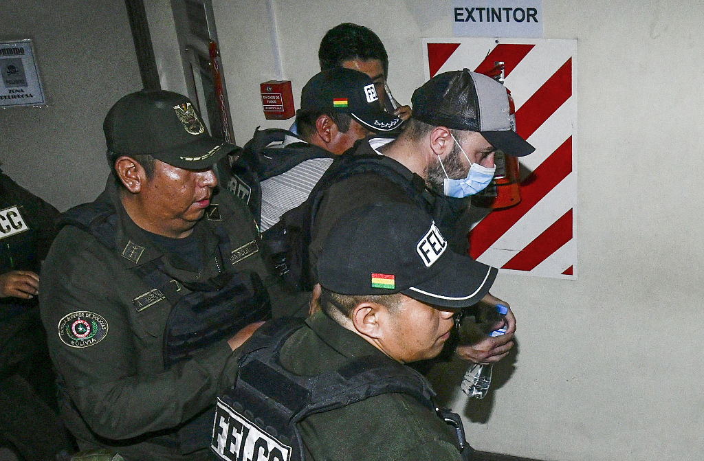Police officers transfer Fernando Cerimedo from the Justice Palace to the Palmasola prison in Santa Cruz, Bolivia, on August 21, 2026.