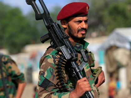A fighter loyal to the Houthi authorities brandishes his weapon during a rally to recruit more fighters in Sanaa, Yemen, on September 10, 2026.