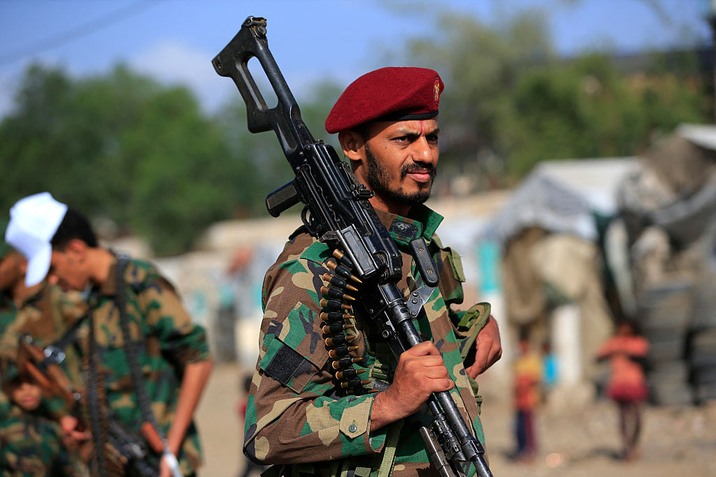A fighter loyal to the Houthi authorities brandishes his weapon during a rally to recruit more fighters in Sanaa, Yemen, on September 10, 2026.