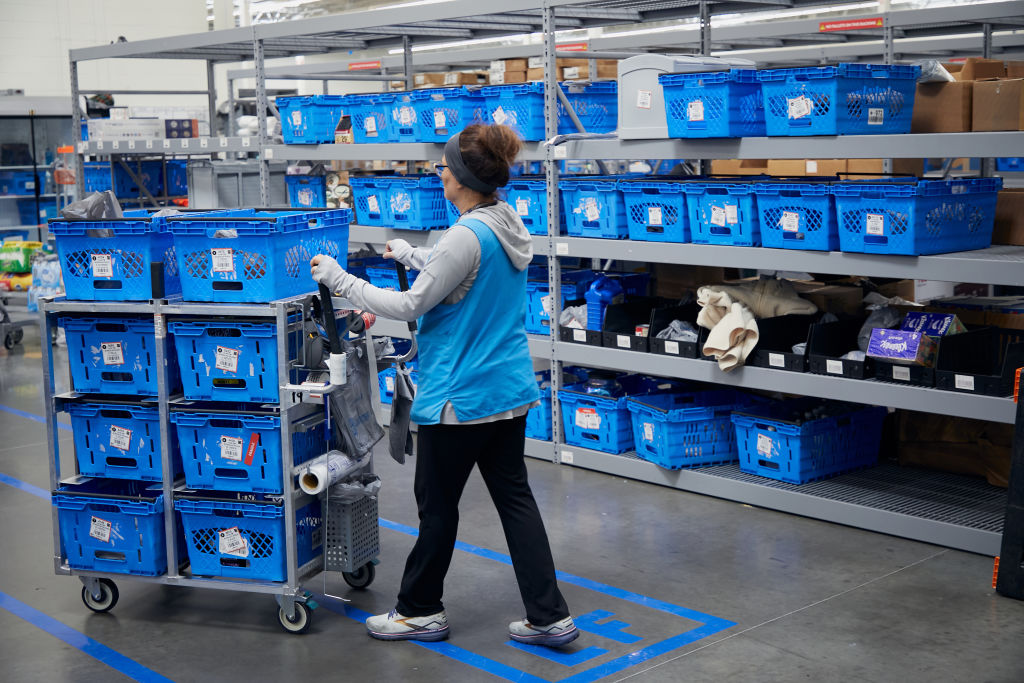 An employee gathers online orders at a Walmart market fulfillment center in the back of a store in Grapevine, Texas, on October 10, 2023.