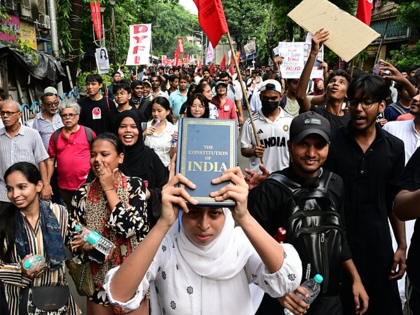 Demonstrators from various student groups, holding banners and flags, attend a protest rally in Kolkata to support the NEET protest organized by the 'Cockroach Janata Party' at Jantar Mantar in Delhi and the demand for the resignation of India's Education Minister, Dharmendra Pradhan on July 24, 2026, in Kolkata, West Bengal, India.