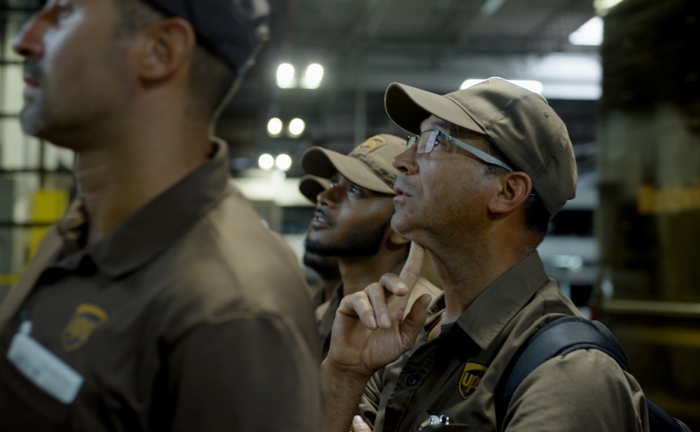 A still featuring three UPS workers from the 2026 documentary Who Moves America